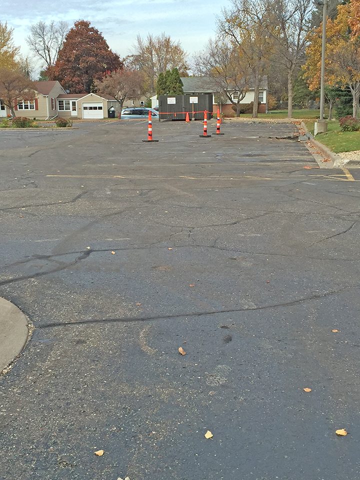 Cracked, worn church parking lot before repaving