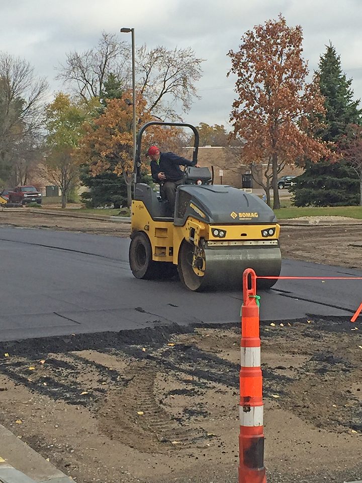 Roller compacting fresh asphalt at the church lot