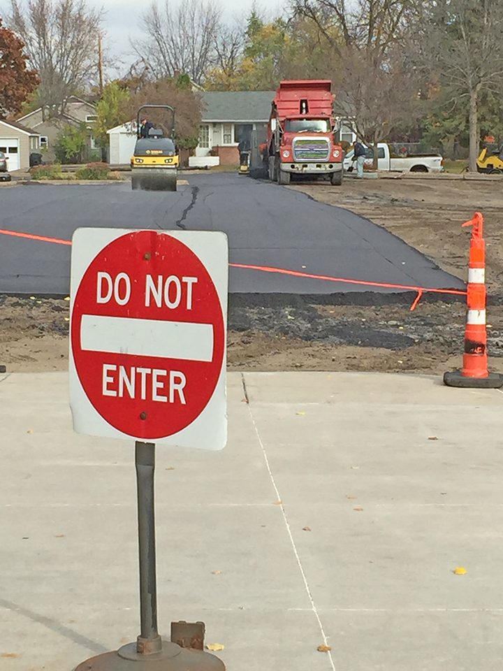 Fresh asphalt being placed on the church parking lot