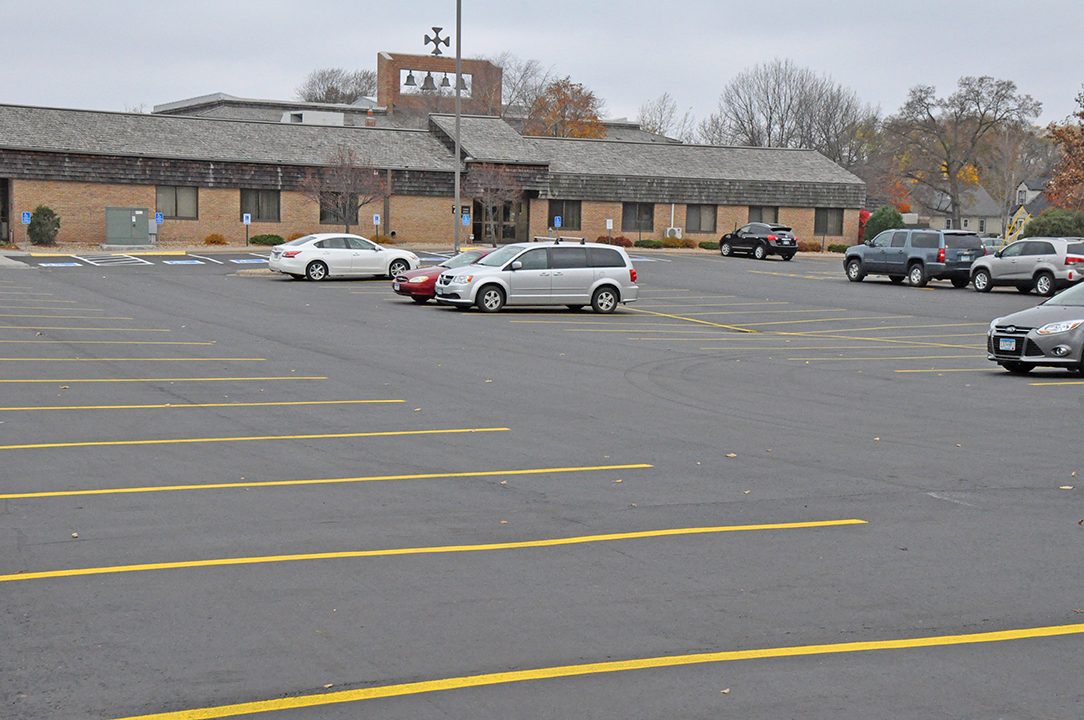 Church parking lot after repaving, with fresh markings